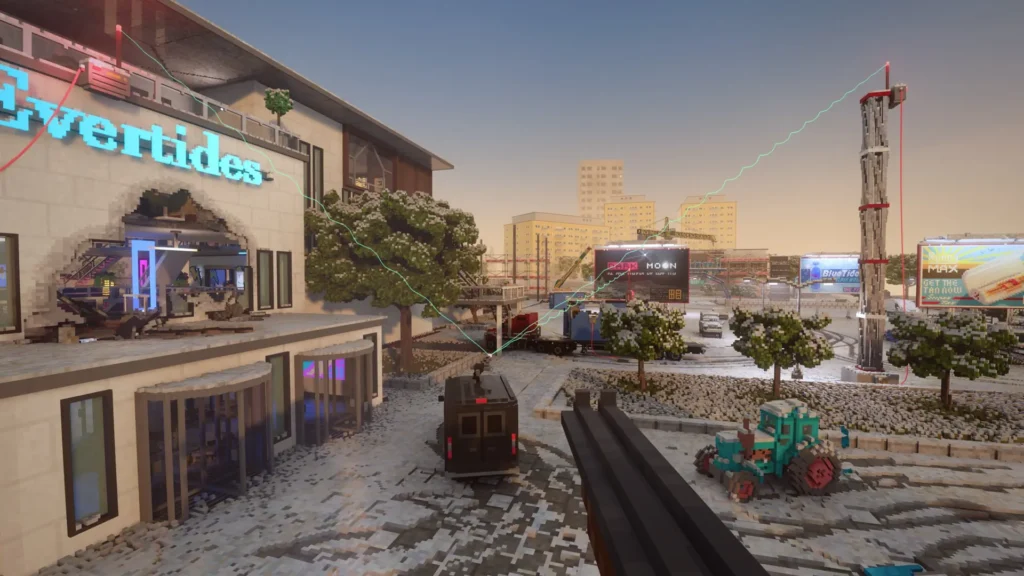 A first-person view screenshot from the game Teardown showing an urban scene with a shotgun barrel in the foreground. A dark van is parked in front of a modern building with a large hole blasted through it. A small blue tractor is on the right, and a chaotic construction site with large billboards is in the background. The scene is covered in a layer of snow and debris.