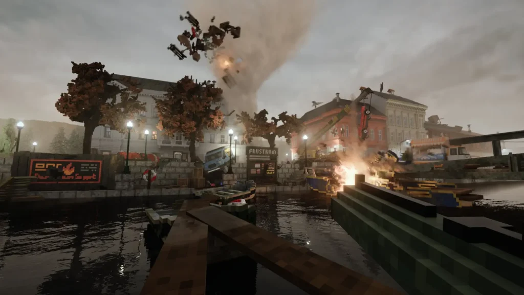 A destructive scene from the game Teardown, showing a vortex of smoke, fire, and debris swirling above a waterfront town. A large green and blue boat is partially submerged in the foreground. On the far side of the water, cars and debris are being lifted into the sky as buildings on the street are on fire and crumbling.
